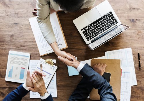 Business people shaking hands together